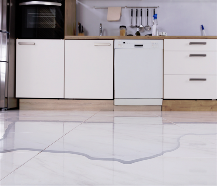 a flooded kitchen with water covering the floor